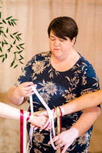 Shelley the celebrant demonstrates a handfasting, conducted as part of a wedding ceremony as the say vows are said