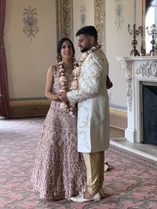 The Bride and Groom pose for photographs in the drawing Room of Hylands House, Essex.