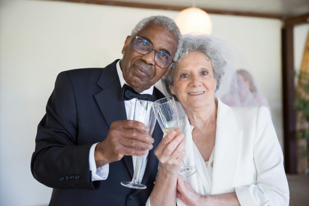 The bride and groom embrace, glasses held aloft at the conclusion of their fabulous wedding speeches.