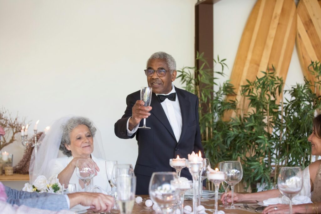 The groom raises a toast at the conclusion of his fabulous wedding speech.