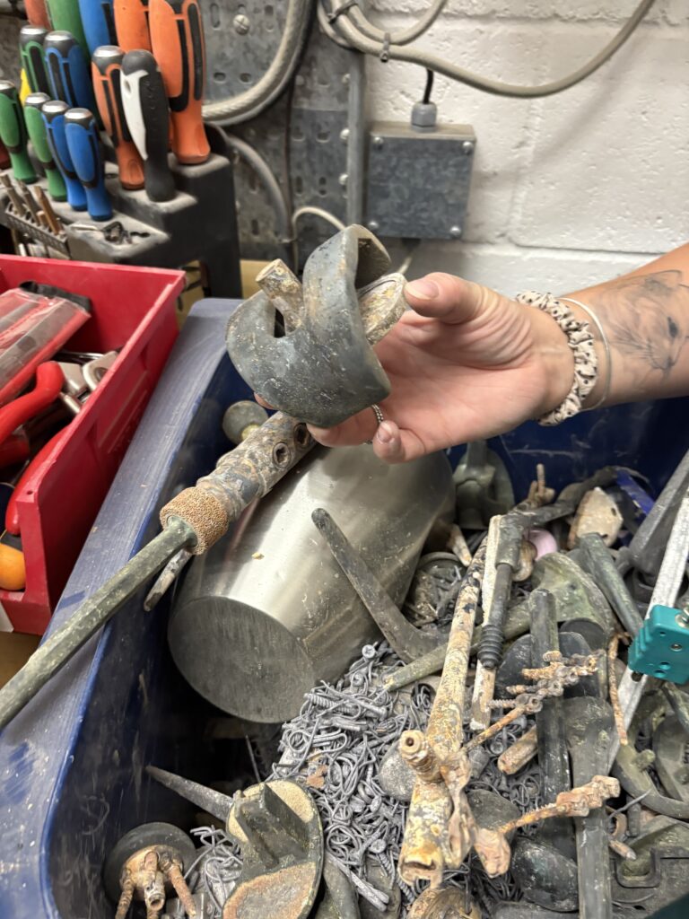 A recycling bin holds all the metal fragments from the cremator, from knee joints like this one to the pin nails that hold the coffin handles on