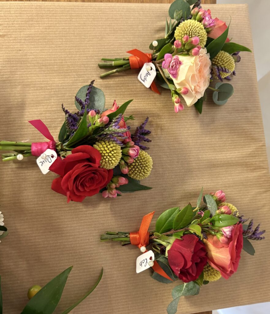 A selection of colourful flowers arranged as buttonholes for guests to wear