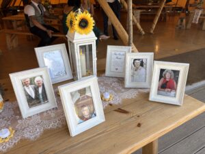 A memorial table of framed photos of loved ones