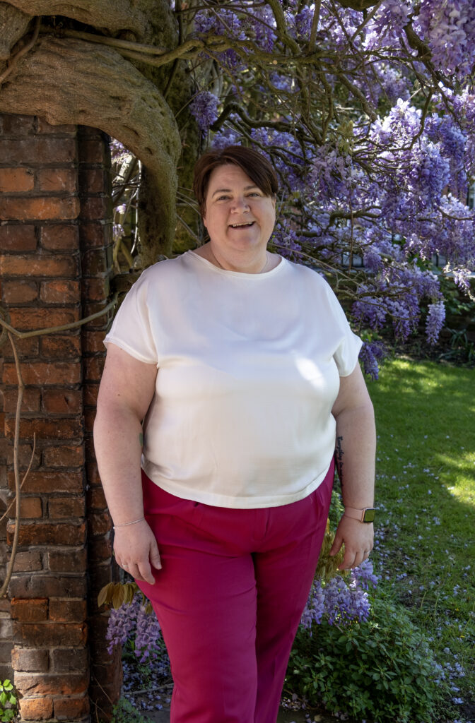 Shelley Bell standing and smiling into the camera