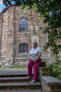 Shelley Bell sits on a wall outside Colchester castle