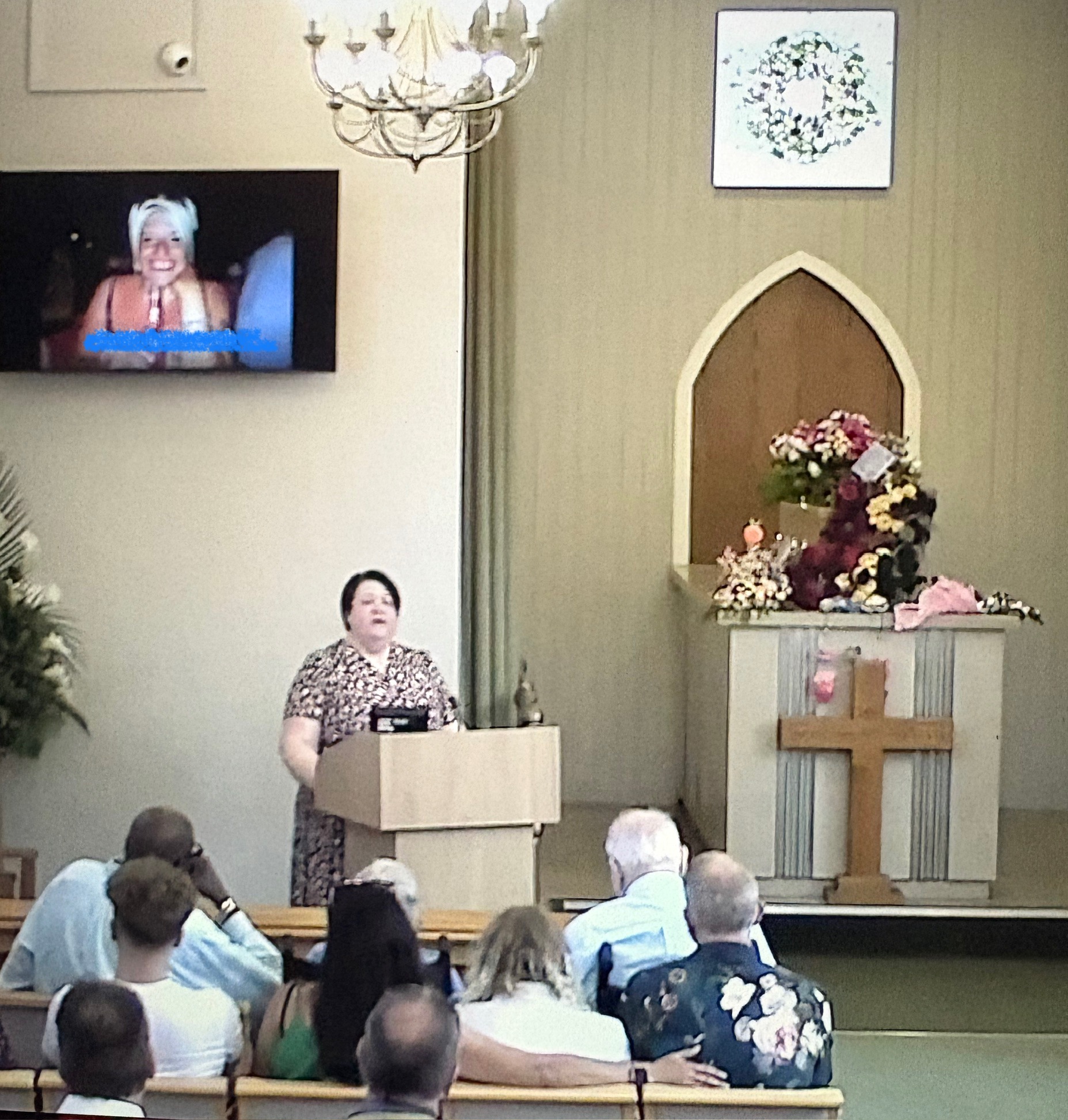 Shelley Bell Celebrant stands at the lectern conducting a Celebration of Life Ceremony