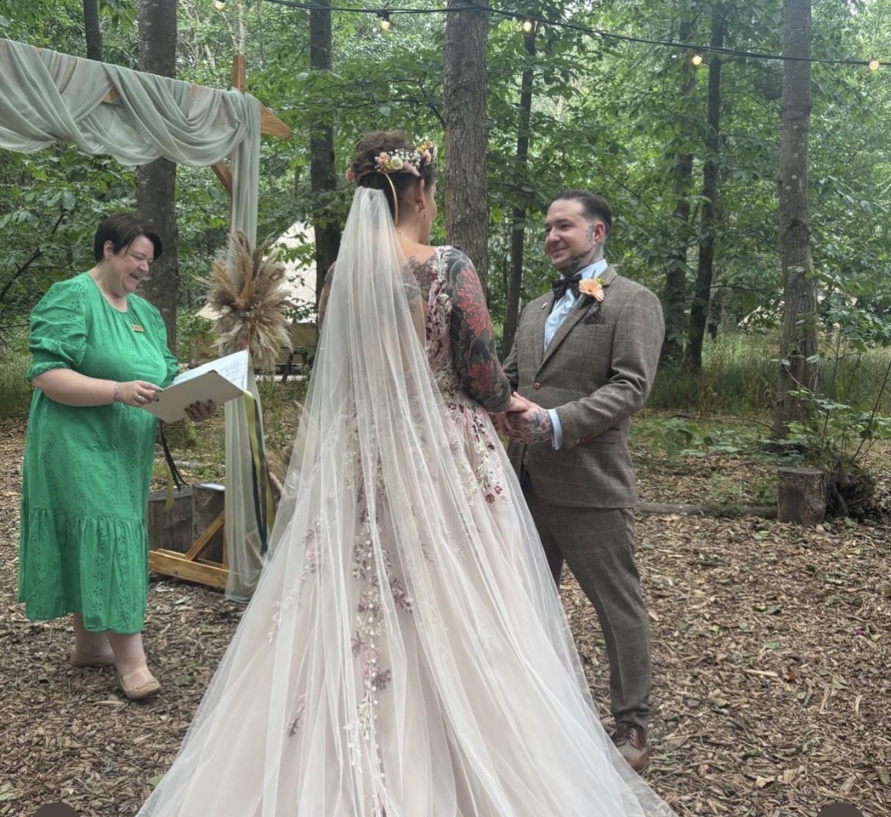 Shelley conducts a ceremony for Hannah and Andy in a woodland setting